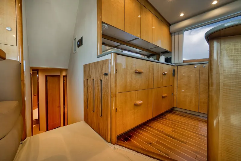 Slide: The Image of Luxurious interior of 2002 Weaver 60 Convertible yacht with wooden cabinetry and flooring. - 14