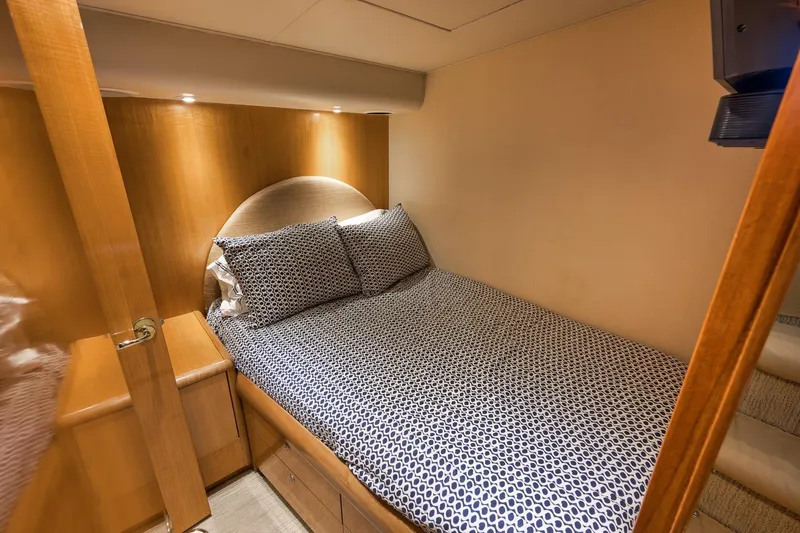 Slide: The Image of Cozy bedroom in 2002 Weaver 60 Convertible yacht with patterned bedding and wooden accents. - 15