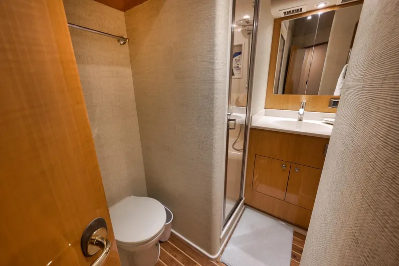 Slide: The Image of Bathroom interior of 2002 Weaver 60 Convertible yacht with shower and wooden cabinetry. - 18