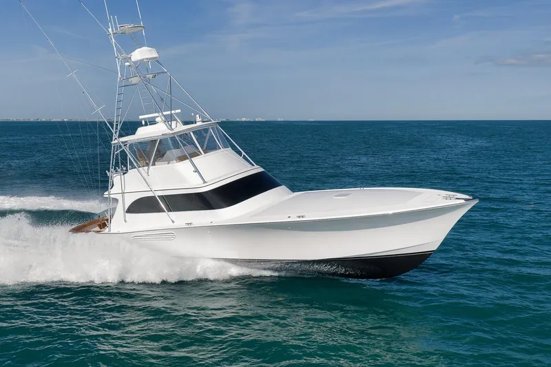 Slide: The Image of 2002 Weaver 60 Convertible yacht cruising on open ocean waters. - 2