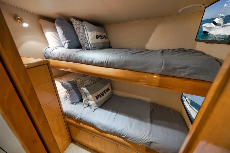 Slide: The Image of Bunk beds in 2002 Weaver 60 Convertible yacht cabin with blue bedding and wooden accents. - 20