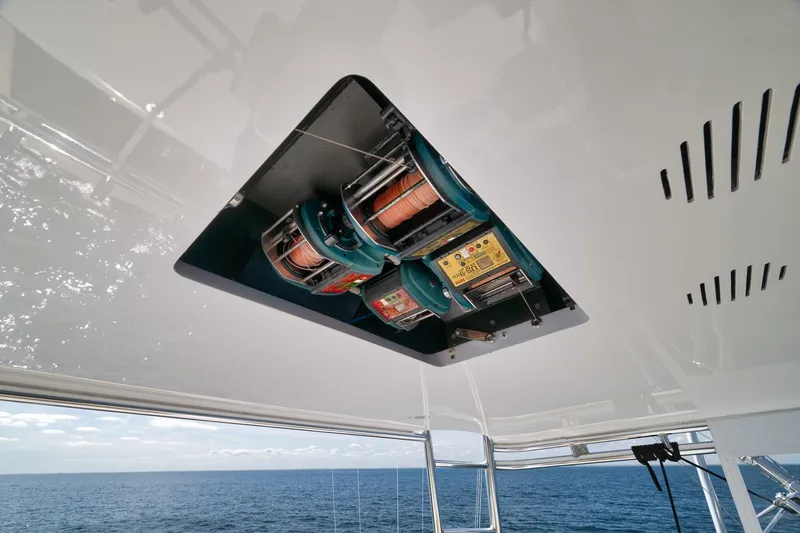 Slide: The Image of Ceiling-mounted fishing reels on a 2002 Weaver 60 Convertible yacht, overlooking the ocean. - 27
