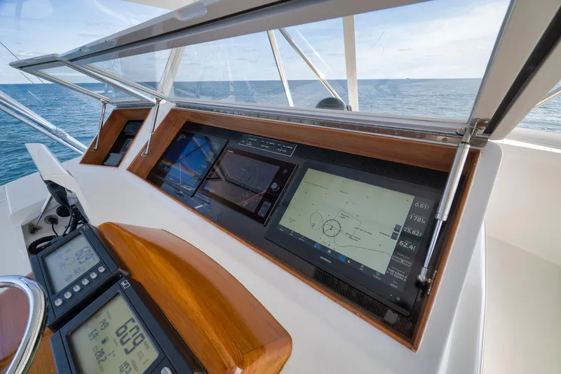 Slide: The Image of Helm of 2002 Weaver 60 Convertible yacht with navigation displays and ocean view. - 33