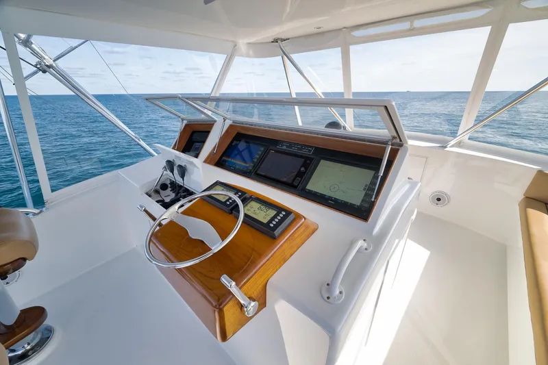 Slide: The Image of Helm of 2002 Weaver 60 Convertible yacht with navigation screens and ocean view. - 34