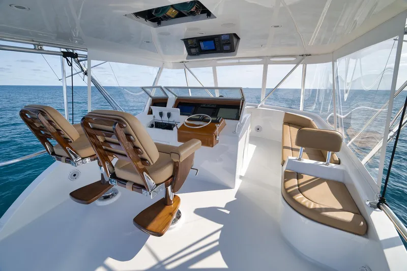 Slide: The Image of Luxurious Weaver 60 Convertible yacht helm with ocean view, featuring plush seating, 2002 model. - 36