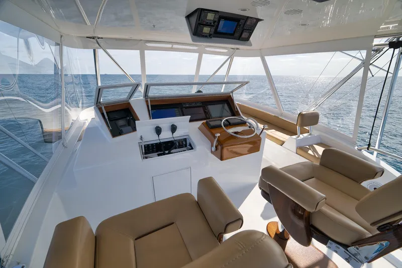 Slide: The Image of Luxurious 2002 Weaver 60 Convertible yacht helm with ocean view and modern controls. - 38