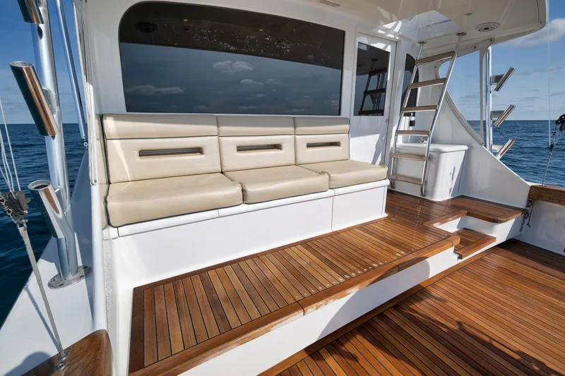 Slide: The Image of Luxurious Weaver 60 Convertible yacht interior with wooden deck and cushioned seating, 2002 model. - 42