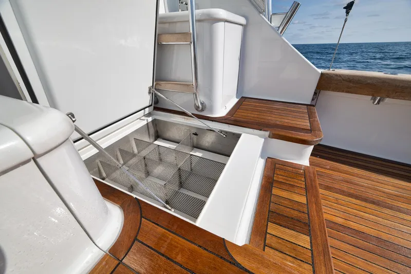 Slide: The Image of Luxury Weaver 60 Convertible yacht deck with wooden flooring and storage compartment, 2002 model. - 49