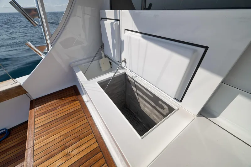 Slide: The Image of Weaver 60 Convertible 2002 yacht deck with open storage compartment, ocean view. - 52