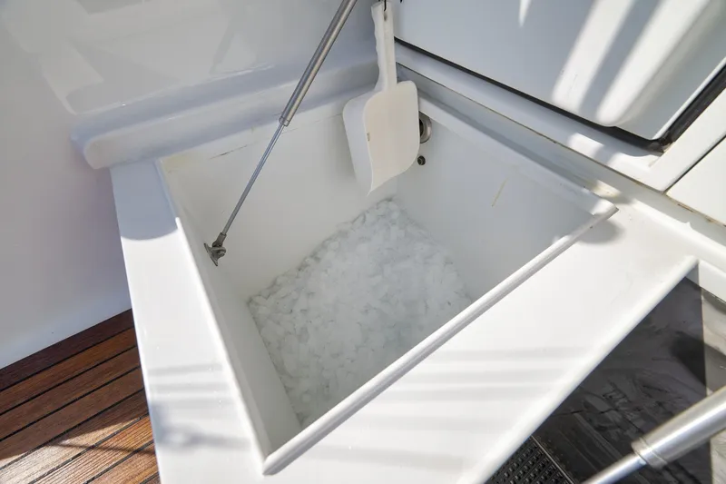 Slide: The Image of Ice-filled compartment on 2002 Weaver 60 Convertible yacht, featuring a white scoop. - 53