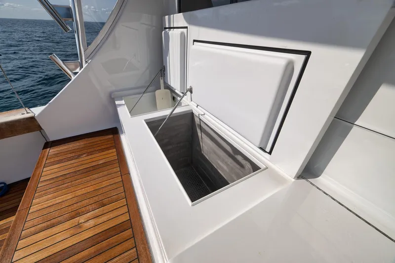 Slide: The Image of Open storage compartment on 2002 Weaver 60 Convertible yacht with wooden deck. - 55