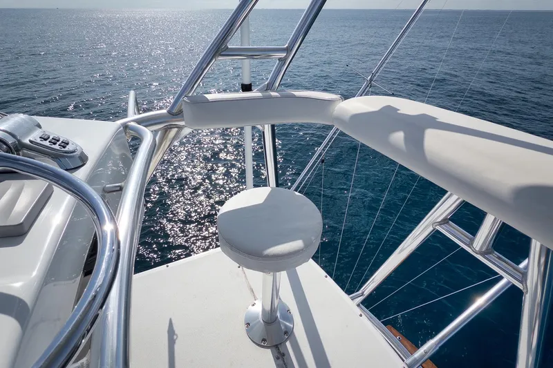 Slide: The Image of 2002 Weaver 60 Convertible yacht helm with ocean view and polished metal details. - 63