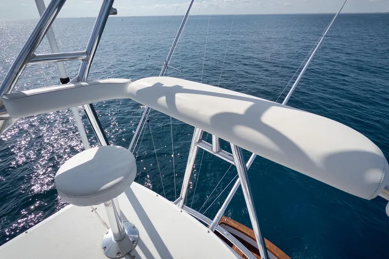 Slide: The Image of Luxury Weaver 60 Convertible yacht helm overlooking serene ocean, 2002 model. - 64