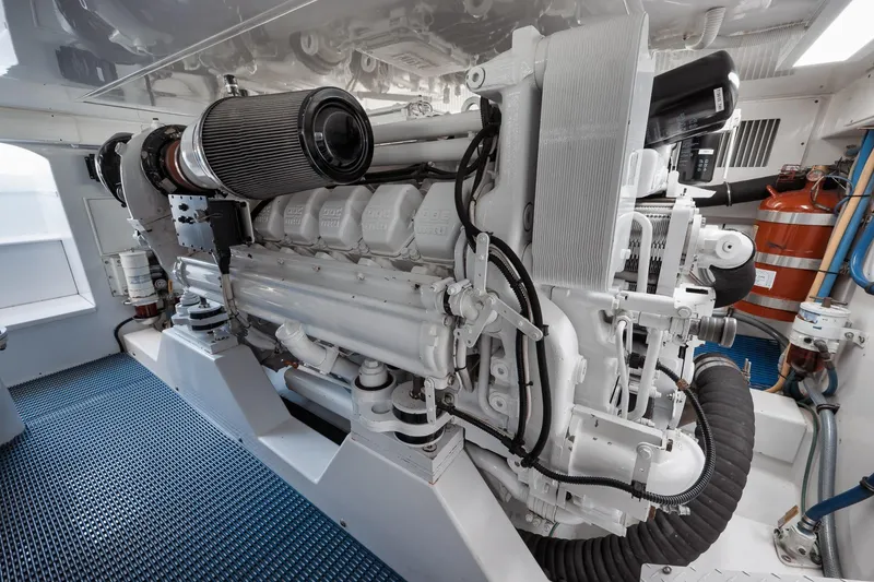 Slide: The Image of Engine room of a 2002 Weaver 60 Convertible yacht, showcasing a powerful marine engine. - 68