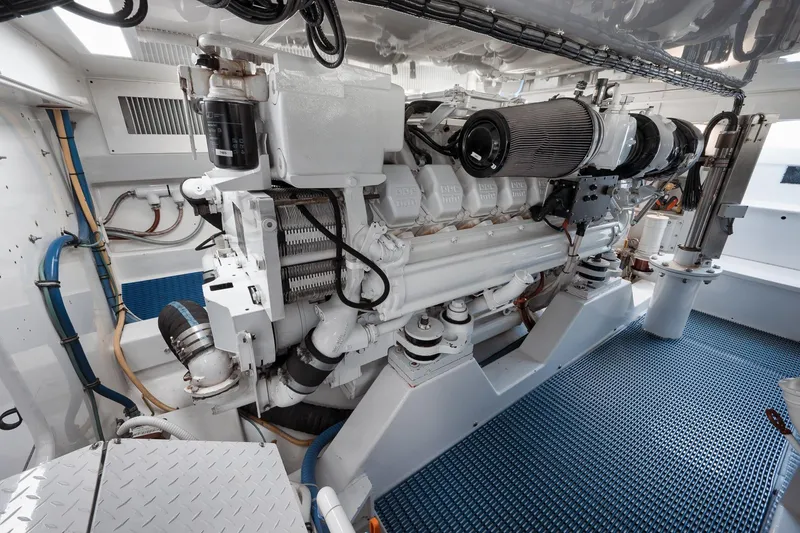 Slide: The Image of Engine room of a 2002 Weaver 60 Convertible yacht, showcasing a powerful marine engine. - 69