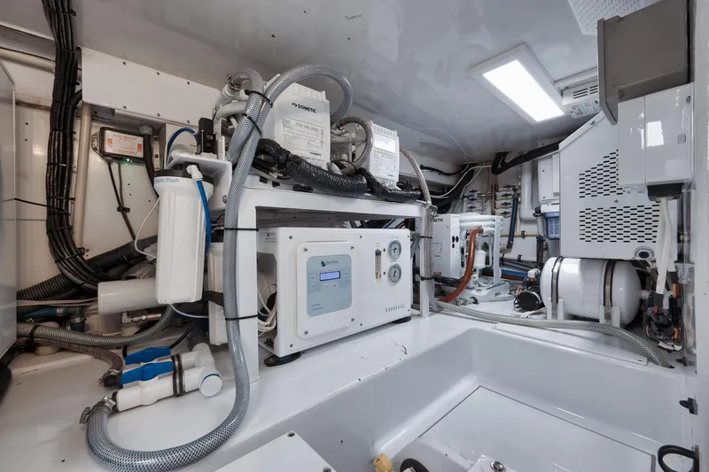 Slide: The Image of Engine room of 2002 Weaver 60 Convertible yacht, featuring advanced mechanical systems and equipment. - 72