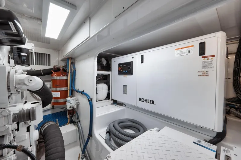 Slide: The Image of Engine room of 2002 Weaver 60 Convertible with Kohler generator and fire extinguisher. - 73