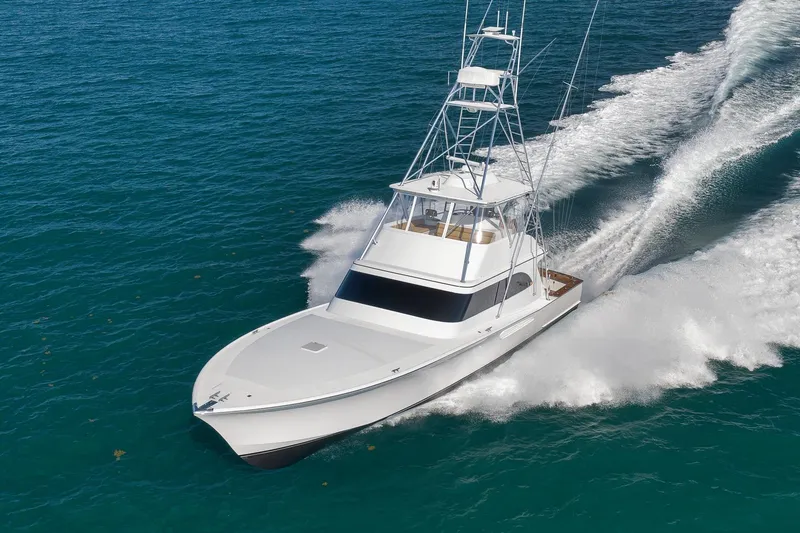 Slide: The Image of 2002 Weaver 60 Convertible yacht cruising on open blue waters. - 79