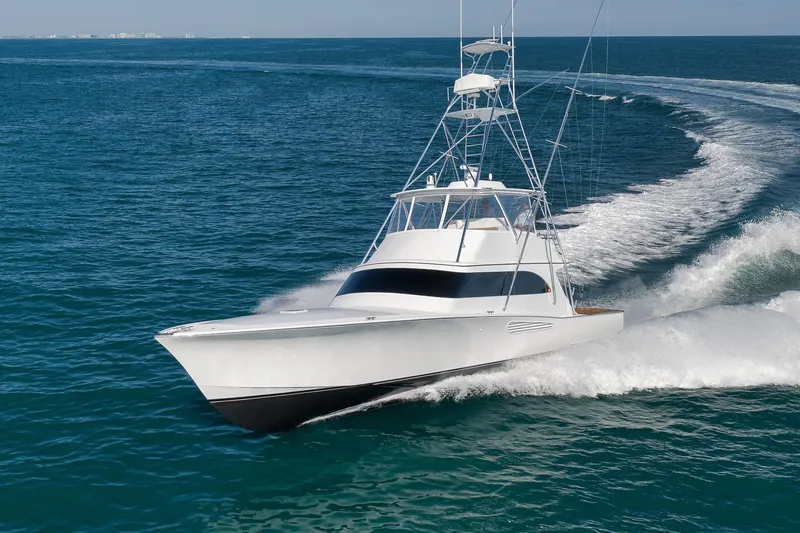 Slide: The Image of 2002 Weaver 60 Convertible yacht cruising on open ocean waters. - 80