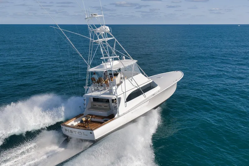 Slide: The Image of 2002 Weaver 60 Convertible yacht cruising on open ocean waters. - 81