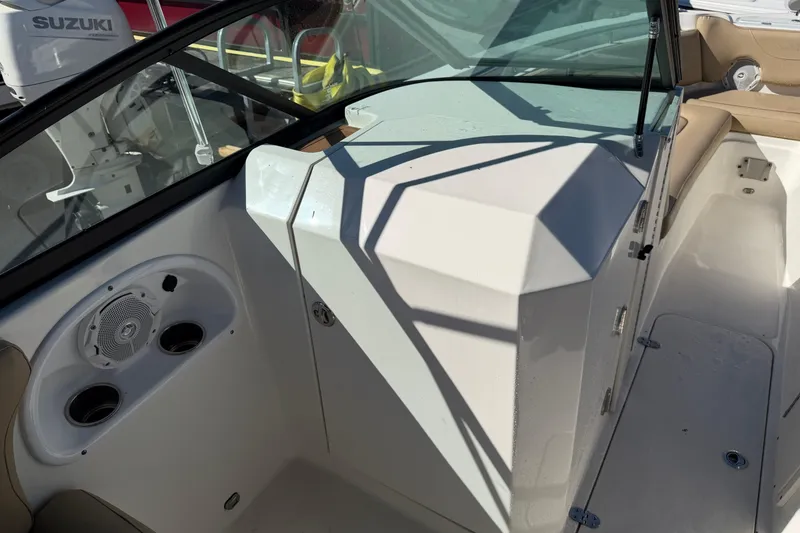 Slide: The Image of 2019 NauticStar 2302 Legacy Dual Console interior with speaker and cup holders. - 10