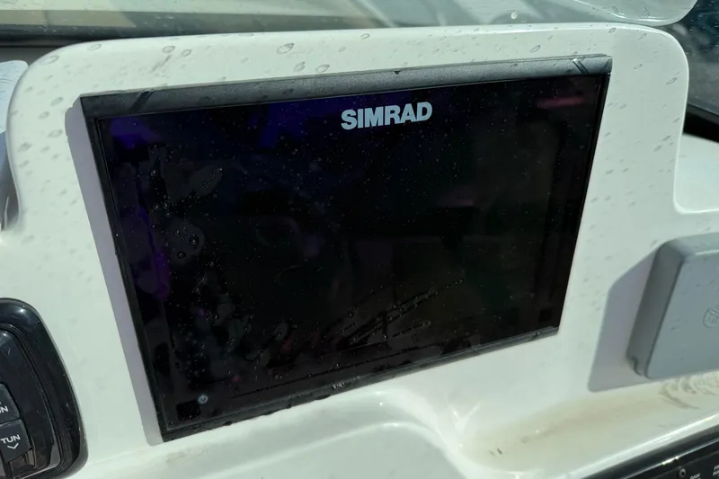 Slide: The Image of Simrad display on 2019 NauticStar 2302 Legacy Dual Console boat dashboard. - 11