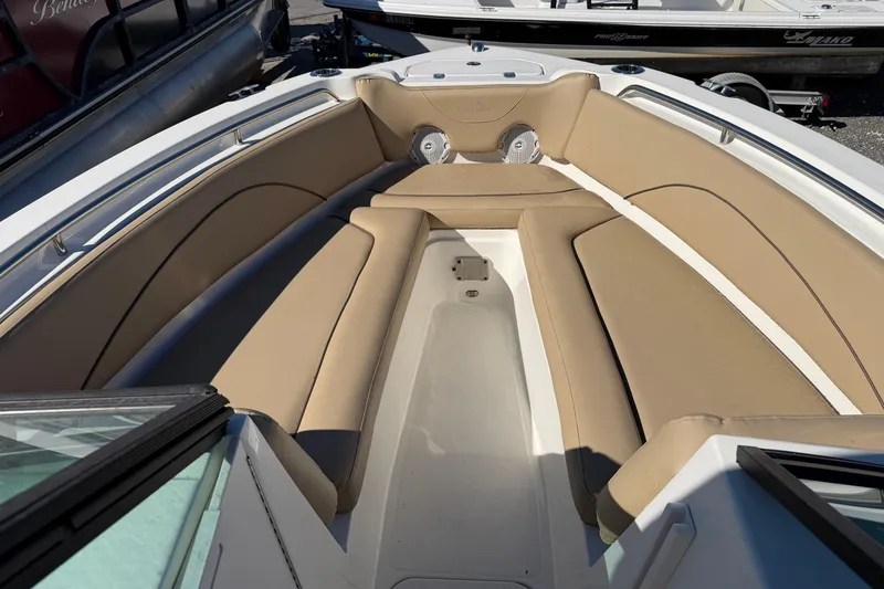 Slide: The Image of 2019 NauticStar 2302 Legacy Dual Console boat with tan seating and spacious bow area. - 12