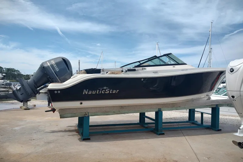 Slide: The Image of 2019 NauticStar 2302 Legacy Dual Console boat on display with Yamaha engine. - 14