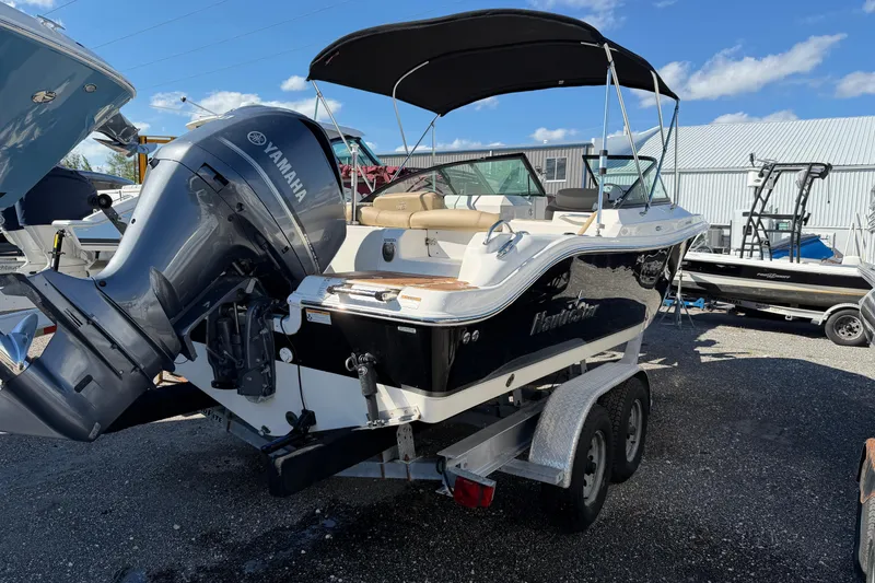 Slide: The Image of 2019 NauticStar 2302 Legacy Dual Console boat with Yamaha engine on trailer. - 3