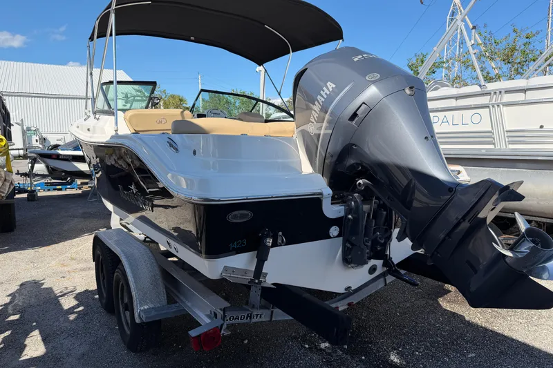 Slide: The Image of 2019 NauticStar 2302 Legacy Dual Console boat with Yamaha engine on trailer. - 5