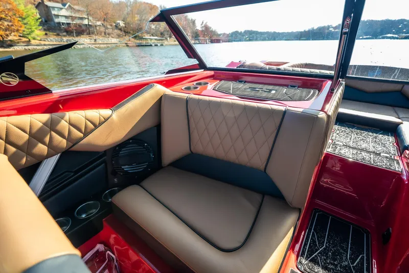 Slide: The Image of 2026 Tigé Z3 boat interior with luxurious tan seating and red accents by the lake. - 12