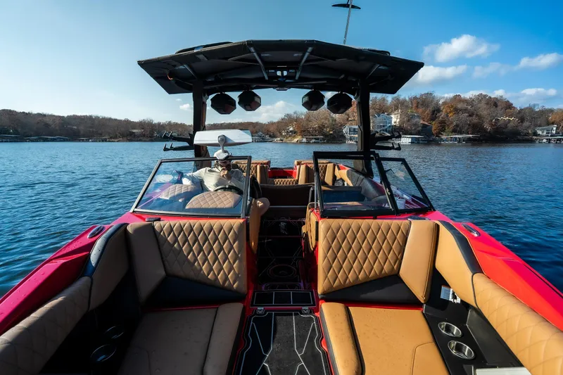 Slide: The Image of 2026 Tigé Z3 boat interior with luxurious seating on a serene lake. - 19