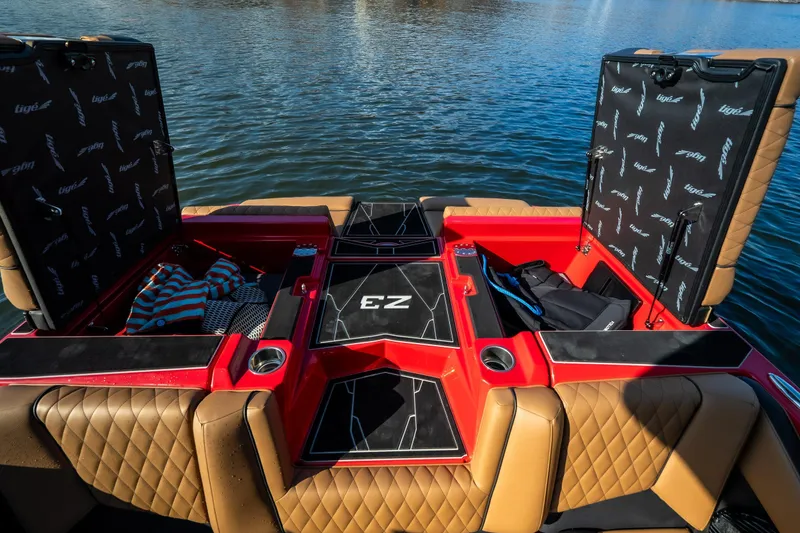 Slide: The Image of 2026 Tigé Z3 boat interior with open storage compartments on a lake. - 20