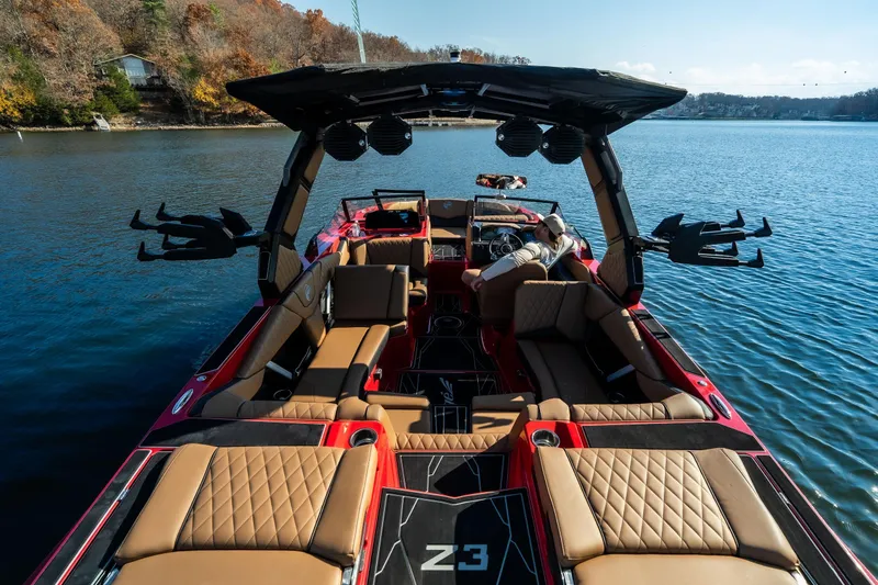 Slide: The Image of 2026 Tigé Z3 boat interior on a serene lake, showcasing luxury seating and modern design. - 24