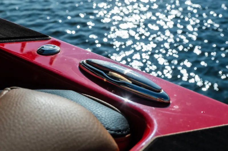 Slide: The Image of 2026 Tigé Z3 boat detail with red trim and water reflections. - 26