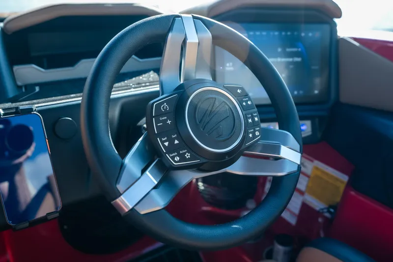 Slide: The Image of Steering wheel and dashboard of 2026 Tigé Z3 boat with control buttons. - 33