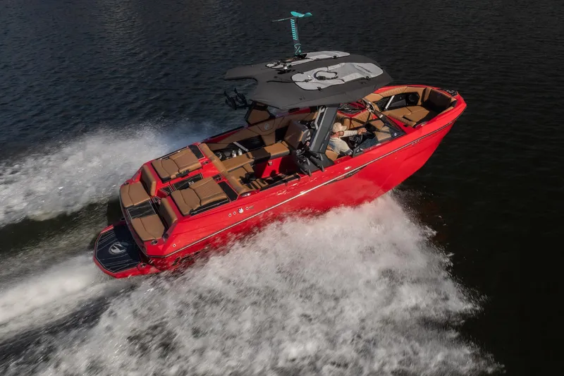 Slide: The Image of 2026 Tigé Z3 boat cruising on water, vibrant red exterior, sleek design. - 4