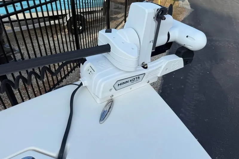 Slide: The Image of Minn Kota trolling motor on 2016 Pathfinder 2200 TRS boat, docked near a fence. - 10