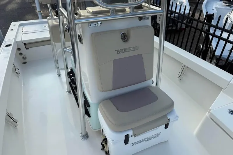 Slide: The Image of 2016 Pathfinder 2200 TRS boat interior with cushioned seating and stainless steel frame. - 11