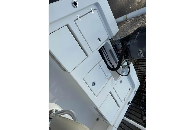 Slide: The Image of 2016 Pathfinder 2200 TRS boat deck with storage compartments and outboard motor. - 15