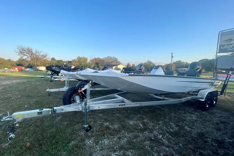 Slide: The Image of 2026 Xpress H20C Crappie boat on trailer, displayed outdoors under clear sky. - 1