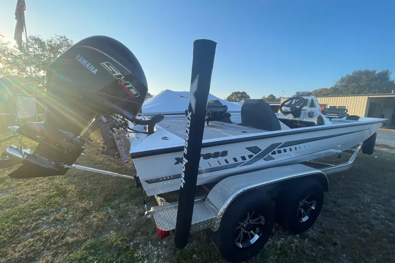 Slide: The Image of 2026 Xpress H20C Crappie boat with Yamaha engine on a trailer, outdoors. - 2