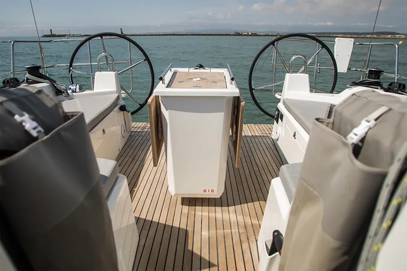 Slide: The Image of Manufacturer Provided Image: 2026 Beneteau Oceanis 40.1 yacht cockpit with dual steering wheels and wooden deck. - 4