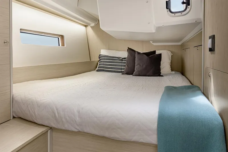 Slide: The Image of Manufacturer Provided Image: Cozy cabin interior of 2026 Beneteau Oceanis 40.1 yacht with modern bedding. - 9