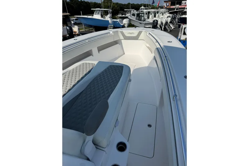 Slide: The Image of 2024 Invincible 36 Open Fisherman boat interior with cushioned seating and storage compartments. - 10