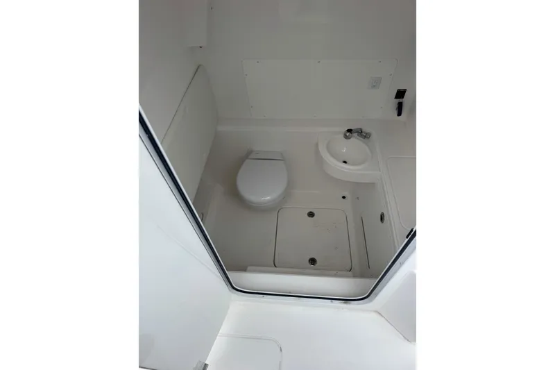 Slide: The Image of 2024 Invincible 36 Open Fisherman boat bathroom with toilet and sink. - 4