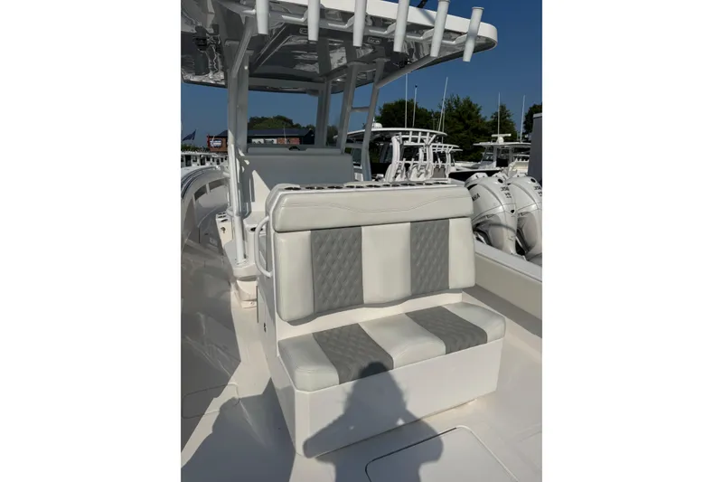 Slide: The Image of 2024 Invincible 36 Open Fisherman boat interior with cushioned seating and rod holders. - 7