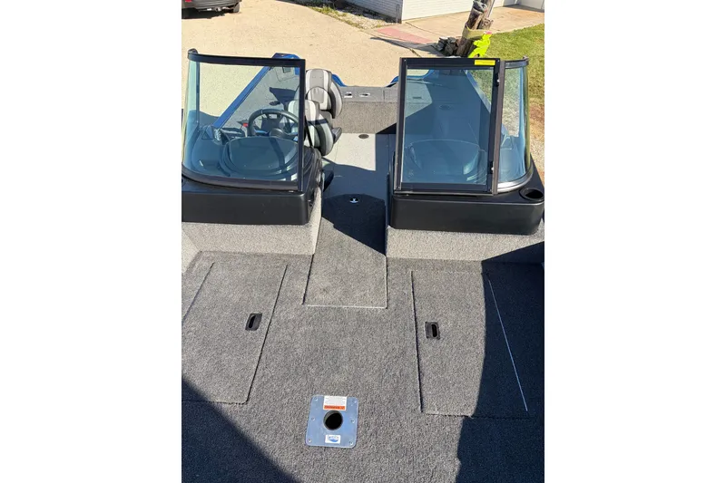 Slide: The Image of 2026 Lowe Fishing Machine 1775WT interior with dual consoles and carpeted deck. - 12