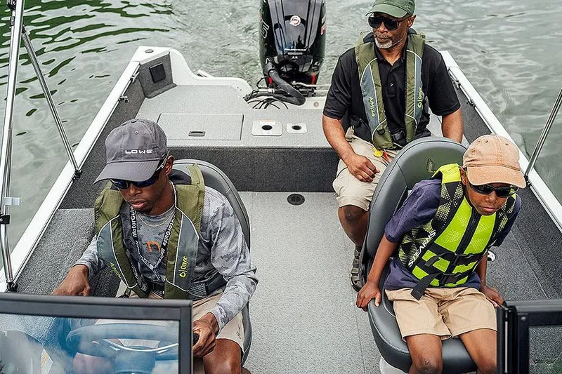 Slide: The Image of Manufacturer Provided Image: Three people on a 2026 Lowe Fishing Machine 1775WT boat, wearing life jackets. - 15