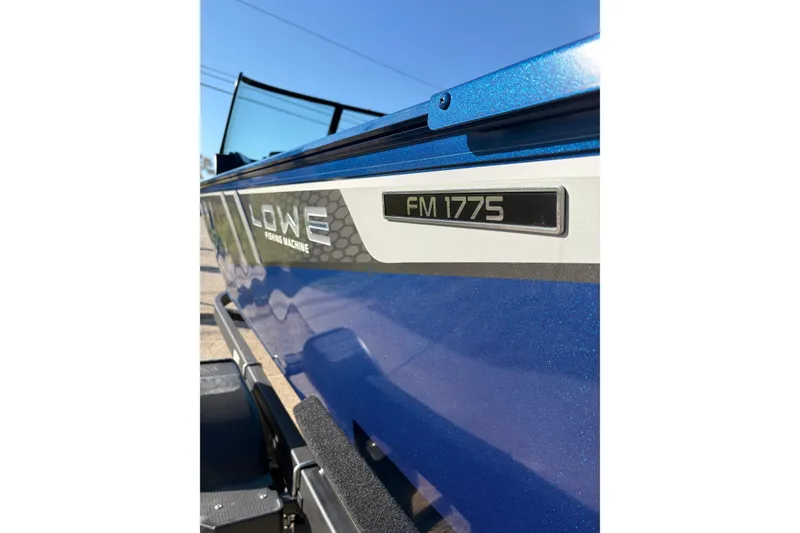 Slide: The Image of 2026 Lowe Fishing Machine 1775WT boat, blue exterior, close-up view. - 3